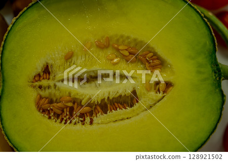 Cut in half cantaloupe melon isolated on white background Cut in half cantaloupe melon isolated on white background 128921502