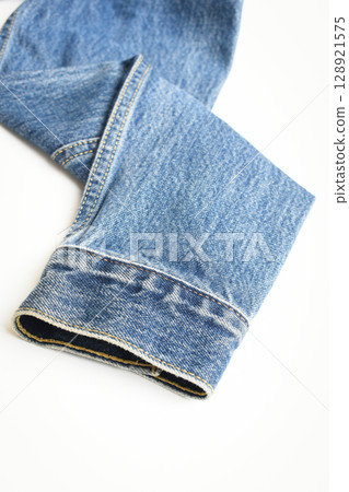 sleeve of blue denim shirt texture isolated on white background, jean fashion style 128921575