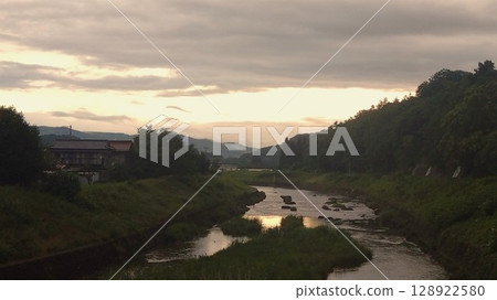 A peaceful riverside scene at dusk A peaceful riverside scene at dusk 128922580