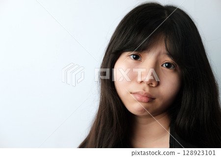 Young Asian Woman with Serious Expression and Copy Space Young Asian Woman with Serious Expression and Copy Space 128923101