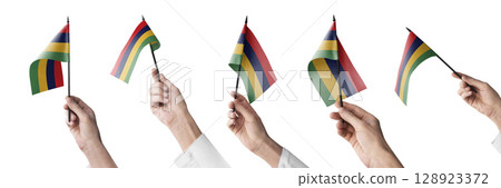 The Mauritius flag in hand in different angles on a white background The Mauritius flag in hand in different angles on a white background 128923372