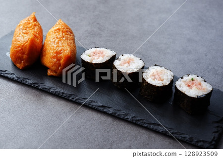 Negitoro rolls and inari sushi - A delicious-looking set of negitoro rolls and inari sushi 128923509