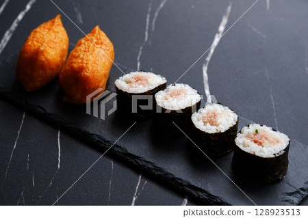 Negitoro rolls and inari sushi - A delicious-looking set of negitoro rolls and inari sushi Negitoro rolls and inari sushi - A delicious-looking set of negitoro rolls and inari sushi 128923513
