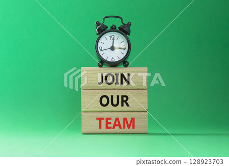 Join our team symbol. Wooden blocks with words Join our team. Beautiful green background with alarm clock. Business and Join our team concept. Copy space. 128923703