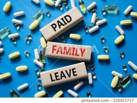 Paid Family Leave symbol. Concept words Paid Family Leave on wooden blocks. Beautiful blue background with pills. Healthcare and Paid Family Leave concept. Copy space. Paid Family Leave symbol. Concept words Paid Family Leave on wooden blocks. Beautiful blue background with pills. Healthcare and Paid Family Leave concept. Copy space. 128923717