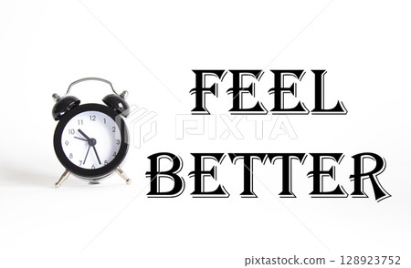 Feel better symbol. Beautiful white background with alarm clock. Business and Feel better concept. Copy space. Feel better symbol. Beautiful white background with alarm clock. Business and Feel better concept. Copy space. 128923752