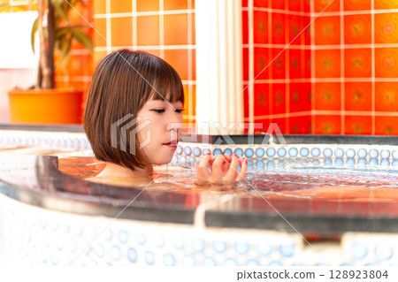 Japanese woman taking a bath Japanese woman taking a bath 128923804
