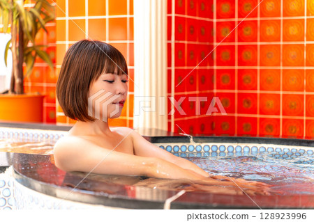 Japanese woman taking a bath 128923996