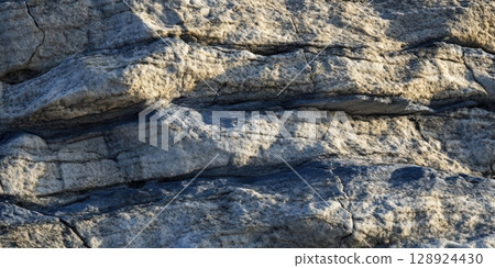 Layered Rock Texture Background Natural Stone Wall Grey Beige hard rough solid cliff earth photo 128924430