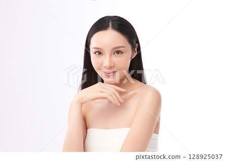 A beautiful young Asian woman with clean, fresh skin against a white background. Skincare, facial treatment, cosmetology, beauty, and spa. An elegant portrait of an Asian woman. A beautiful young Asian woman with clean, fresh skin against a white background. Skincare, facial treatment, cosmetology, beauty, and spa. An elegant portrait of an Asian woman. 128925037