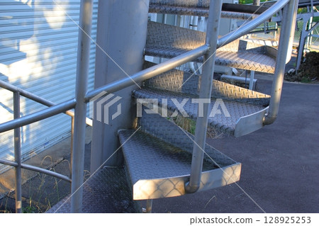 A spiral staircase outside the factory 128925253