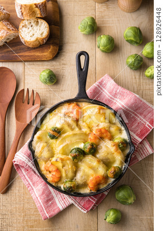 Baked new potatoes and Brussels sprouts with cheese Baked new potatoes and Brussels sprouts with cheese 128926448