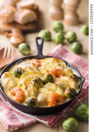 Baked new potatoes and Brussels sprouts with cheese Baked new potatoes and Brussels sprouts with cheese 128926449