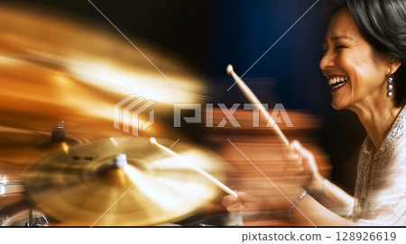 Enthusiastic drummer performing live in jazz club with blurred motion Enthusiastic drummer performing live in jazz club with blurred motion 128926619