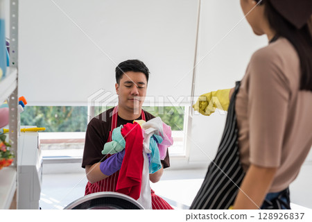 Bossy Asian wife point finger and force sad husband to launder shirts Bossy Asian wife point finger and force sad husband to launder shirts 128926837