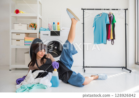 Asian naughty young woman stretching leg during laundry wait 128926842