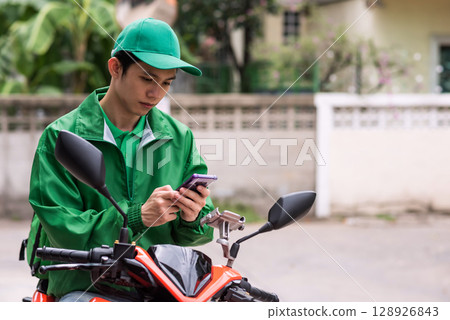 courier deliveryman on motorbike receive food order from phone 128926843