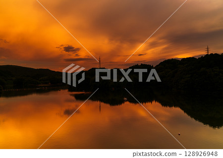 Summer 2025: The sunset covering the sky above Lake Nunome and its reflection on the lake surface ➅ 128926948