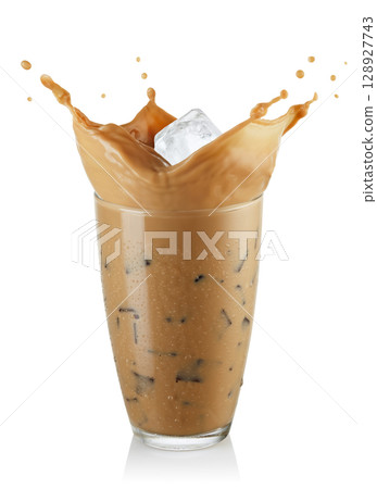 Splash cold coffee with milk and ice in glass isolated on white background Splash cold coffee with milk and ice in glass isolated on white background 128927743