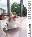 Soft serve ice cream with lotus flower jam served on a table by the window 128928424
