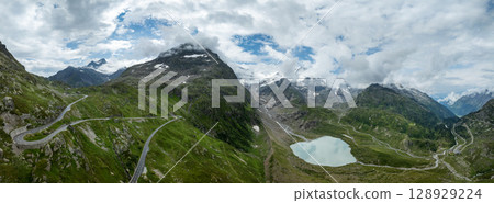 Panoramic view of summer landscape in the Swiss Alps with clear mountain lake and glacier Panoramic view of summer landscape in the Swiss Alps with clear mountain lake and glacier 128929224