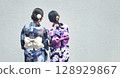 Back view of two women wearing yukatas, with their hair arranged 128929867