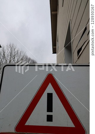 A red and white sign with an exclamation point on it A red and white sign with an exclamation point on it 128930167