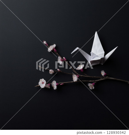 White origami bird and cherry twig evokes sense of peace on black background, minimalist and elegant composition that feels serene and hopeful White origami bird and cherry twig evokes sense of peace on black background, minimalist and elegant composition that feels serene and hopeful 128930342