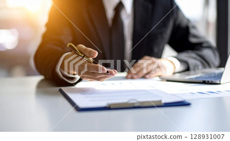 Businessman reaching out to a customer with a proposal 128931007