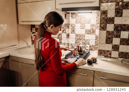Woman Kitchen Cooking Coffee: Home cooking preparation, modern kitchen, woman making coffee. Woman Kitchen Cooking Coffee: Home cooking preparation, modern kitchen, woman making coffee. 128931245