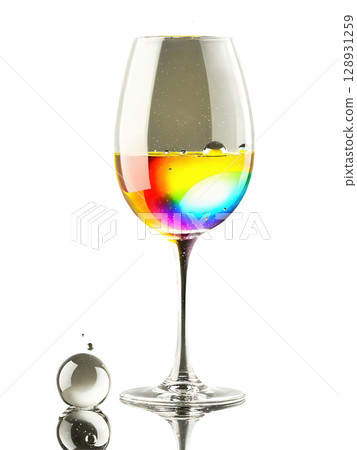 Dessert wine glass, small bowl design, floating droplets, rainbow light effects, professional studio shot Dessert wine glass, small bowl design, floating droplets, rainbow light effects, professional studio shot 128931259