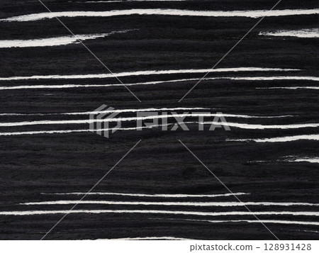 Ebony and ivory veneer surface with bold, rhythmic stripes creating a striking visual contrast Ebony and ivory veneer surface with bold, rhythmic stripes creating a striking visual contrast 128931428