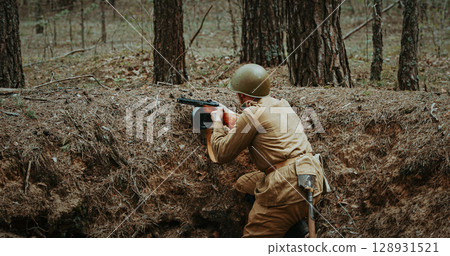 Soldier Aiming in a Forest During Historical Warfare Scene. Soviet Russian Soldier Aiming With Rifles. Soldiers Shoots With Rifle. Soviet Russian Soldier Uniform 128931521