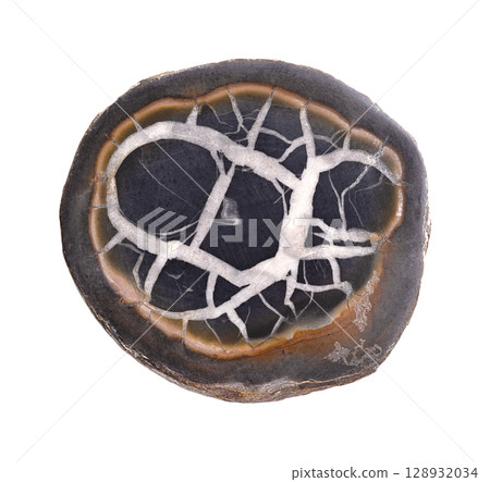 Septarian dragon nodule, polished cross section of a geode. Concretions formed from sedimentary rock, containing cracks and cavities filled with minerals, resembling dragon skin. Isolated, from above. Septarian dragon nodule, polished cross section of a geode. Concretions formed from sedimentary rock, containing cracks and cavities filled with minerals, resembling dragon skin. Isolated, from above. 128932034