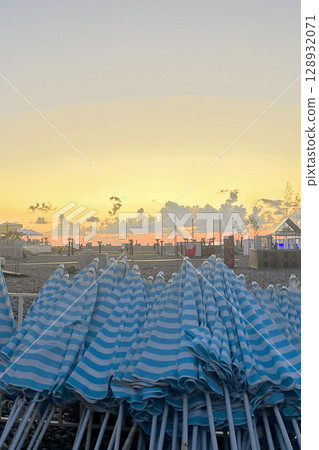 Sunset Beach with Umbrellas, Summer Background 128932071