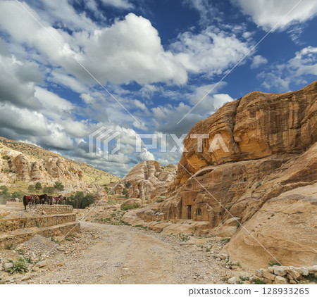 Mountains of Petra (against the background of a beautiful sky with clouds), Jordan, Middle East. Petra has been a UNESCO World Heritage Site since 1985 Mountains of Petra (against the background of a beautiful sky with clouds), Jordan, Middle East. Petra has been a UNESCO World Heritage Site since 1985 128933265