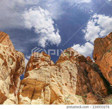 Mountains of Petra (against the background of a beautiful sky with clouds), Jordan, Middle East. Petra has been a UNESCO World Heritage Site since 1985 128933278