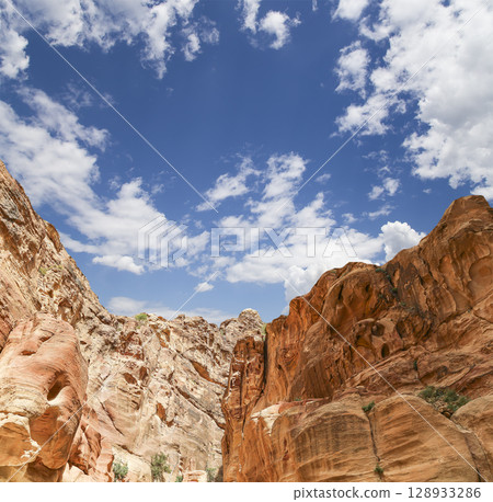 Mountains of Petra (against the background of a beautiful sky with clouds), Jordan, Middle East. Petra has been a UNESCO World Heritage Site since 1985 Mountains of Petra (against the background of a beautiful sky with clouds), Jordan, Middle East. Petra has been a UNESCO World Heritage Site since 1985 128933286