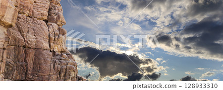 Mountains of Petra (against the background of a beautiful sky with clouds), Jordan, Middle East. Petra has been a UNESCO World Heritage Site since 1985 Mountains of Petra (against the background of a beautiful sky with clouds), Jordan, Middle East. Petra has been a UNESCO World Heritage Site since 1985 128933310
