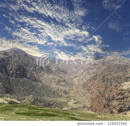 Typical mountain landscape, Jordan, Middle East (photography from a high point). Against the background of a beautiful sky with clouds Typical mountain landscape, Jordan, Middle East (photography from a high point). Against the background of a beautiful sky with clouds 128933560