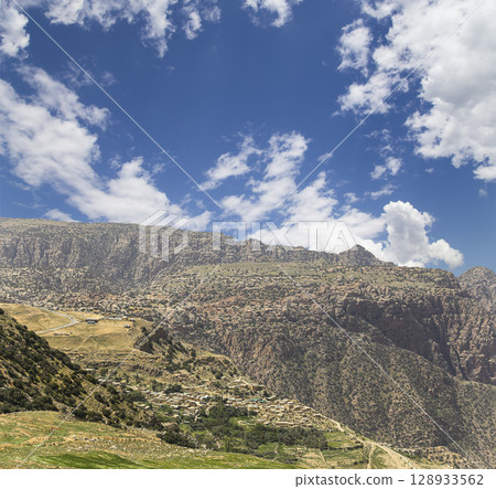 Typical mountain landscape, Jordan, Middle East  (photography from a high point). Against the background of a beautiful sky with clouds Typical mountain landscape, Jordan, Middle East  (photography from a high point). Against the background of a beautiful sky with clouds 128933562