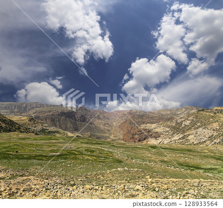Typical mountain landscape, Jordan, Middle East  (photography from a high point). Against the background of a beautiful sky with clouds Typical mountain landscape, Jordan, Middle East  (photography from a high point). Against the background of a beautiful sky with clouds 128933564