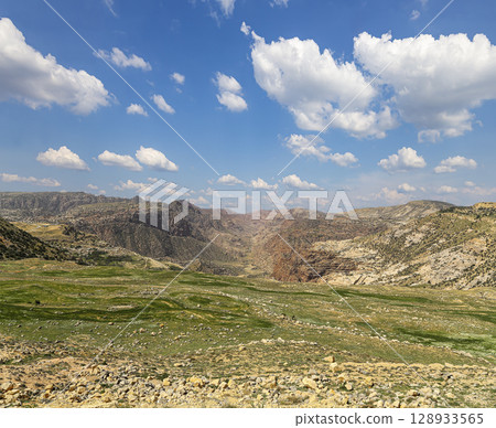 Typical mountain landscape, Jordan, Middle East  (photography from a high point). Against the background of a beautiful sky with clouds Typical mountain landscape, Jordan, Middle East  (photography from a high point). Against the background of a beautiful sky with clouds 128933565