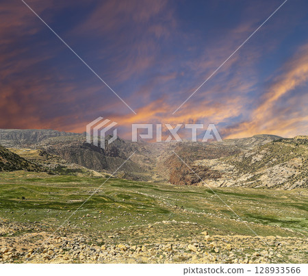 Typical mountain landscape, Jordan, Middle East (photography from a high point). Against the background of a beautiful sky with clouds Typical mountain landscape, Jordan, Middle East (photography from a high point). Against the background of a beautiful sky with clouds 128933566