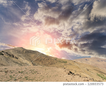 Typical mountain landscape, Jordan, Middle East  (photography from a high point). Against the background of a beautiful sky with clouds Typical mountain landscape, Jordan, Middle East  (photography from a high point). Against the background of a beautiful sky with clouds 128933573