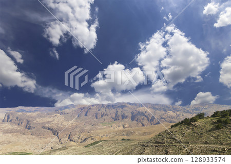 Typical mountain landscape, Jordan, Middle East (photography from a high point). Against the background of a beautiful sky with clouds Typical mountain landscape, Jordan, Middle East (photography from a high point). Against the background of a beautiful sky with clouds 128933574