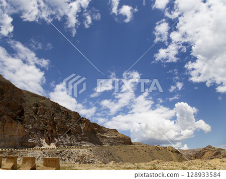Typical mountain landscape, Jordan, Middle East  (photography from a high point). Against the background of a beautiful sky with clouds 128933584