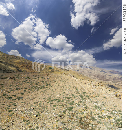 Typical mountain landscape, Jordan, Middle East  (photography from a high point). Against the background of a beautiful sky with clouds 128933596