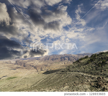 Typical mountain landscape, Jordan, Middle East  (photography from a high point). Against the background of a beautiful sky with clouds 128933603