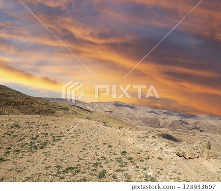 Typical mountain landscape, Jordan, Middle East (photography from a high point). Against the background of a beautiful sky with clouds Typical mountain landscape, Jordan, Middle East (photography from a high point). Against the background of a beautiful sky with clouds 128933607